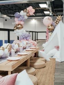 thrive gymnastics aurora birthday party pink purple gold teepee setup