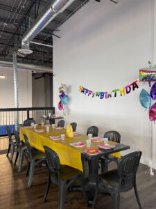thrive gymnastics aurora birthday party yellow tablecloth balloon letters