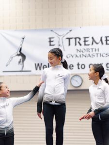 thrive gymnastics aurora ontario gymnasts celebrating with candy after competition
