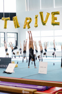 thrive gymnastics aurora team handstand line thrive balloons