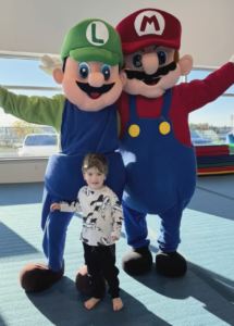 mario luigi mascots with toddler