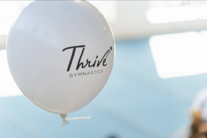 thrive gymnastics balloon branding